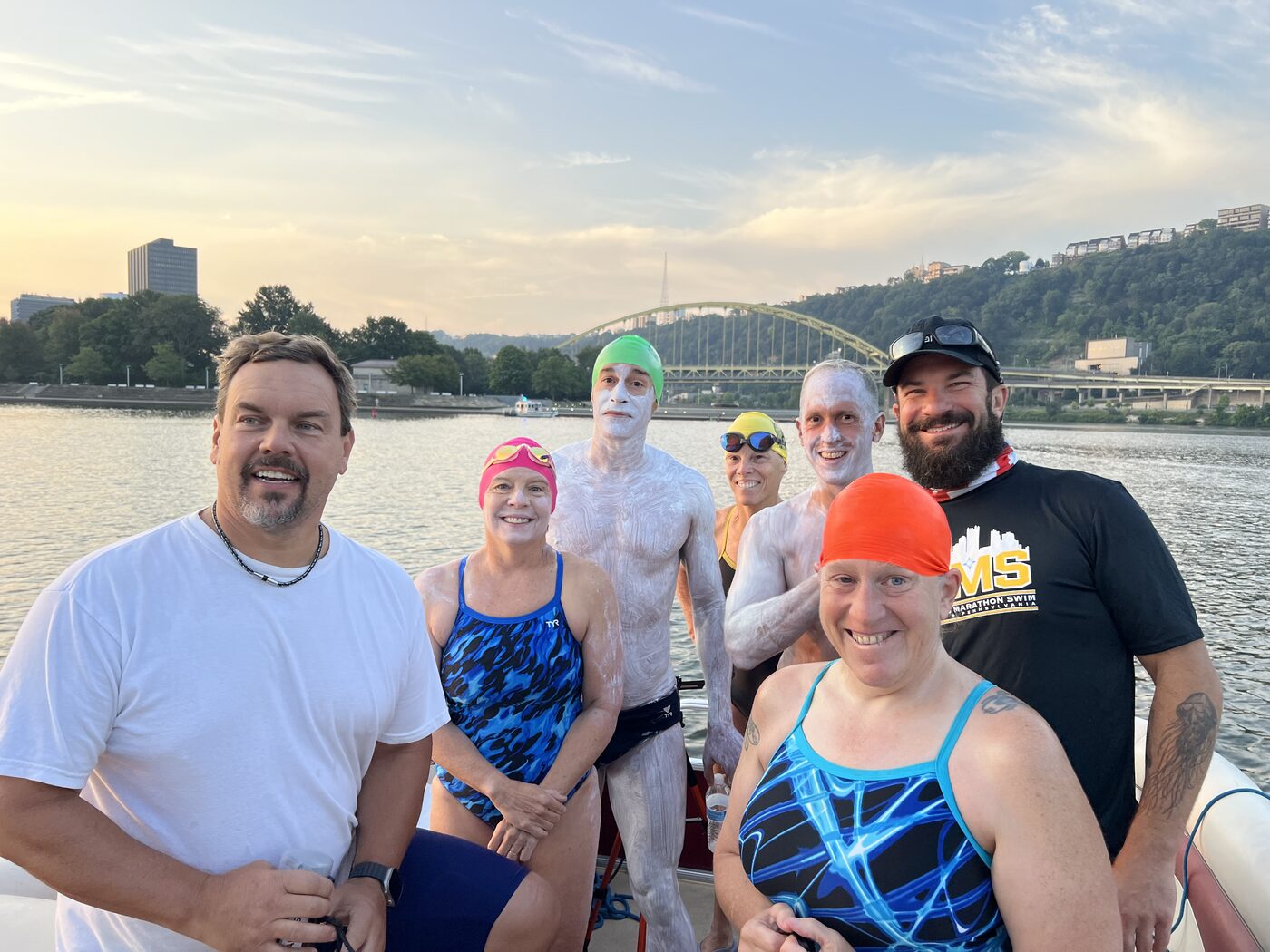 Swimmers and crew aboard an escort boat before the start.